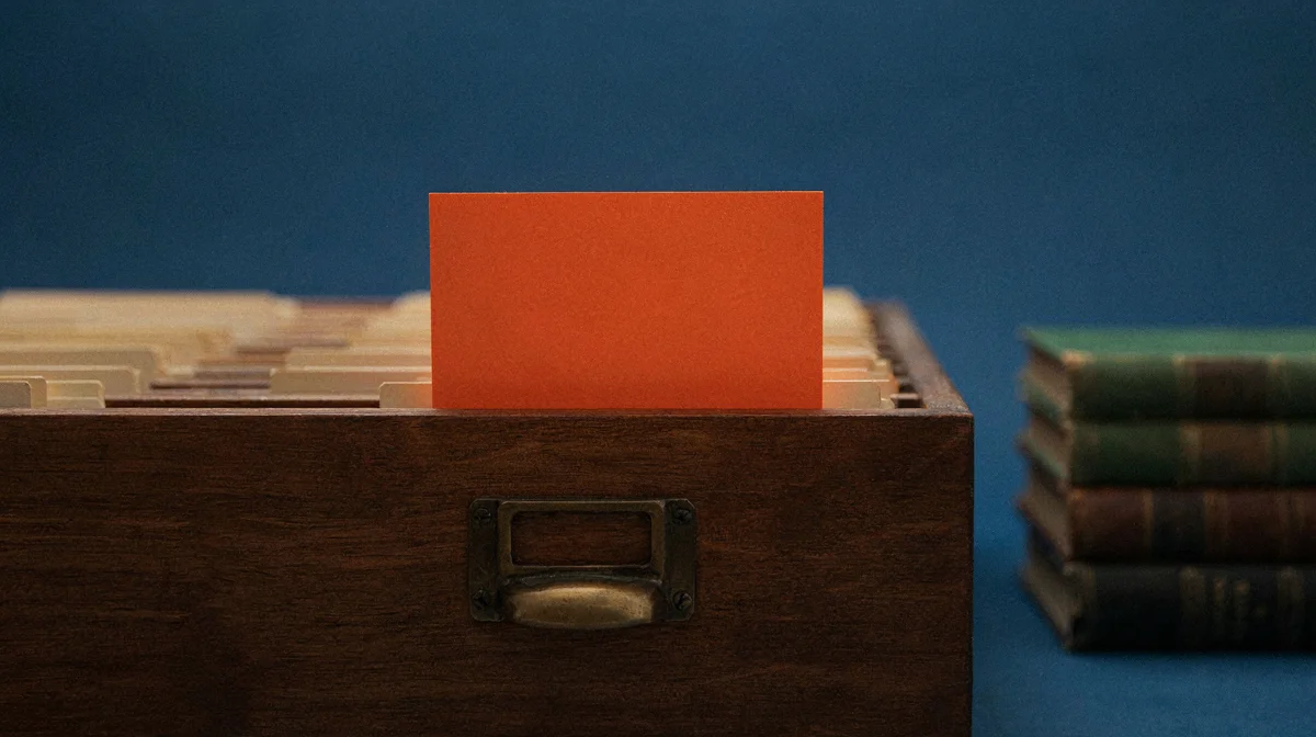 A glowing index card pulled from a library card catalog drawer, representing retrieval-augmented generation connecting an AI model to real company documents