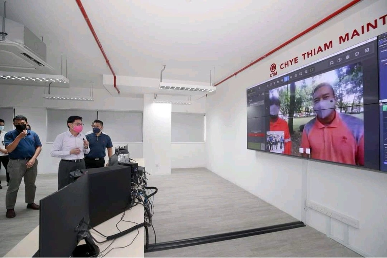 DPM Heng Swee Keat briefed on the live video wall showing field worker verification