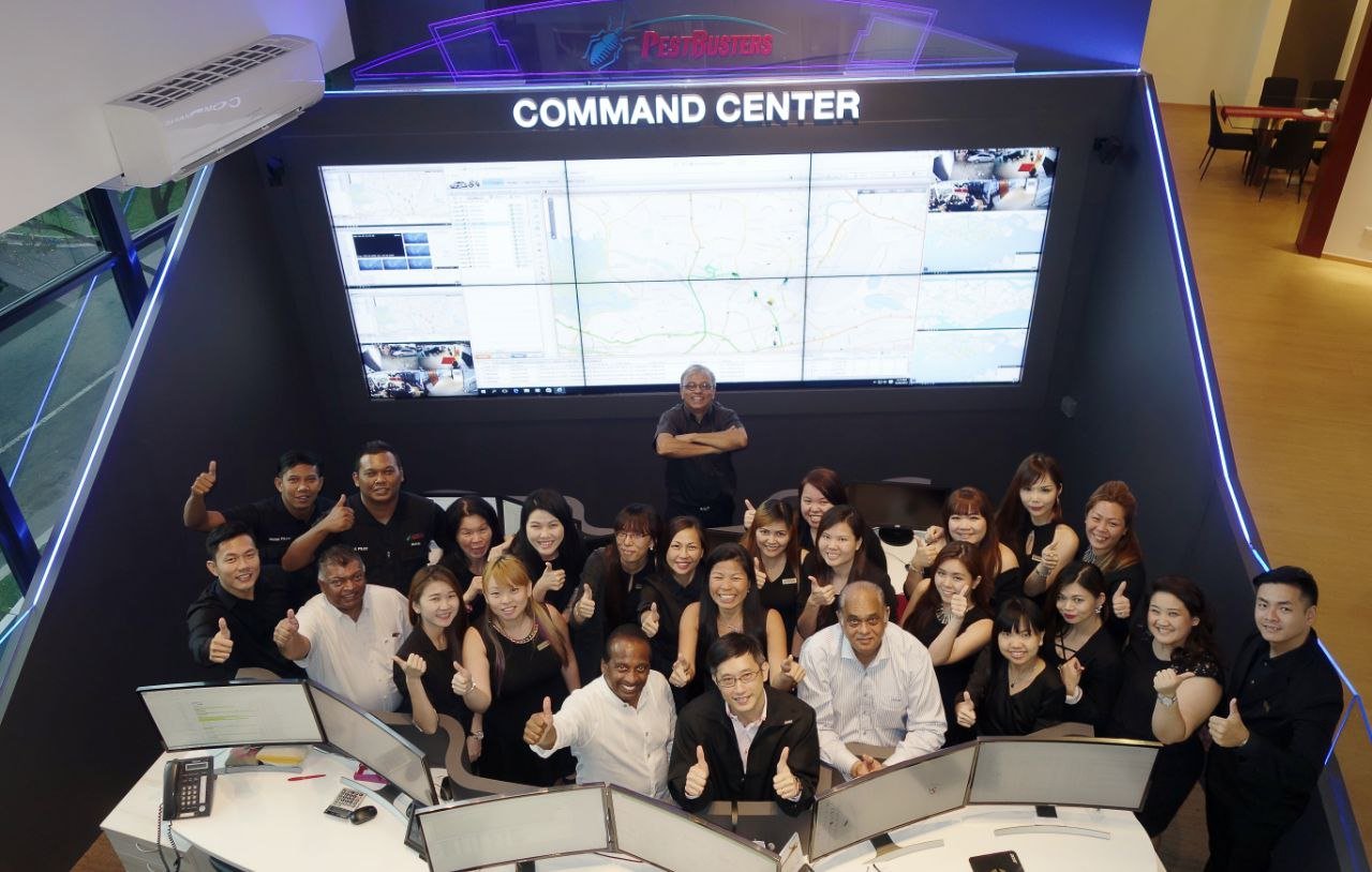 PestBusters command centre team photo beneath the operations wall display
