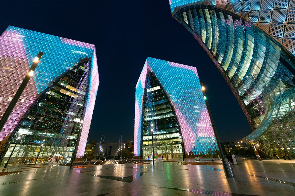 Digital City, Riyadh at night, illuminated angular glass towers of the smart technology park