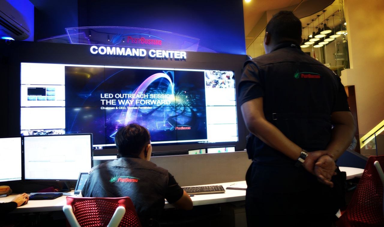 PestBusters command centre, operations team briefing beneath the live wall display